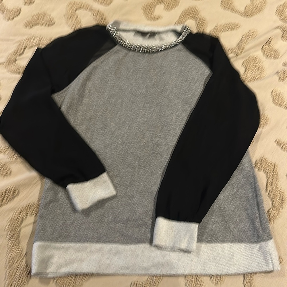 Women’s grey sweatshirt with sheer black sleeves and embellished jewel neckline